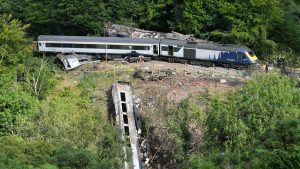 File photo dated 13/08/20 of emergency services inspecting the scene near Stonehaven, Aberdeenshire, following the derailment of the ScotRail train which cost the lives of three people. Prosecutors are considering whether Network Rail will face charges over a train crash which claimed three lives. Issue date: Thursday January 26, 2023.