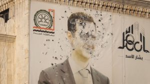 An image of Syrian President Bashar al Assad riddled with bullets at the provincial government office building in Hama. Pic: AP