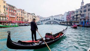 FILE PHOTO: A gondola is pictured on Grand Canal in front of Rialto bridge in Venice, Italy, October 20, 2021. REUTERS/Fabrizio Bensch/File Photo