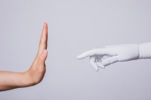 human hand raised rejecting robotic hand (concepts of human rejecting AI)