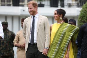 Prince Harry, Duke of Sussex, and Meghan, Duchess of Sussex, react as Lagos State Governor, Babajide Sanwo-Olu (unseen), gives a speech at the State Governor House in Lagos on May 12, 2024 as they visit Nigeria as part of celebrations of Invictus Games anniversary.