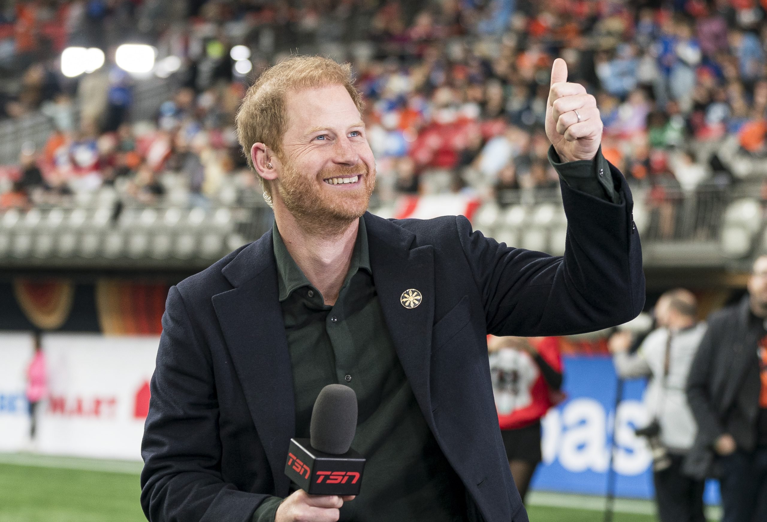 Prince Harry acknowledges fans prior to the start of a TV interview during pre-game festivities before the start of the 2024 Grey Cup at BC Place on November 17, 2024 in Vancouver, Canada.