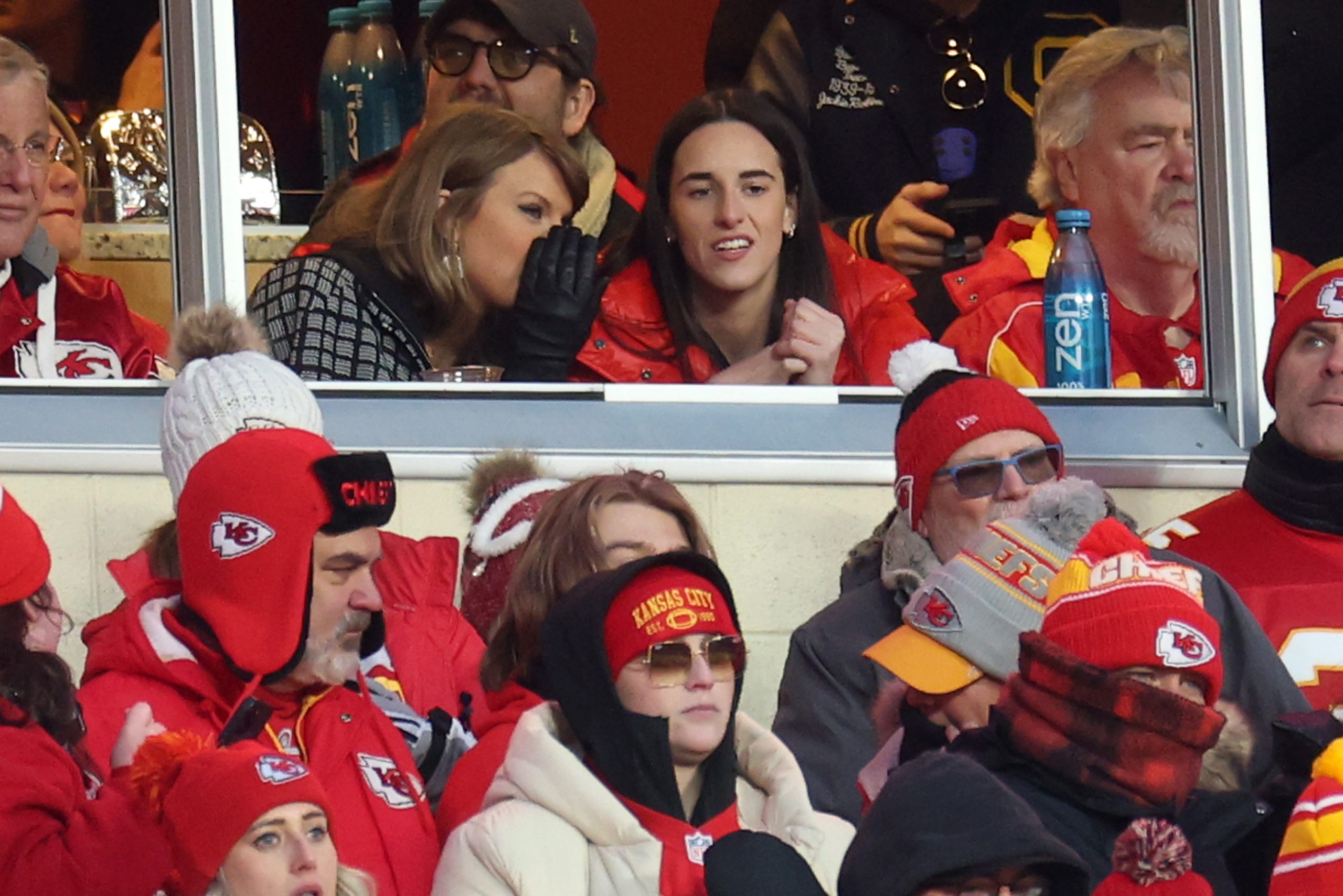 Taylor Swift talks with Caitlin Clark of the Indiana Fever during the second half in the AFC Divisional Playoff between the Houston Texans and the Kansas City Chiefs at GEHA Field at Arrowhead Stadium on January 18, 2025 in Kansas City, Missouri.