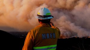 Fires threaten more neighbourhoods as LA braces for high winds