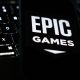 A laptop keyboard and Epic Games logo displayed on a phone screen are seen in this illustration photo taken in Krakow, Poland on October 1, 2024. (Photo by Jakub Porzycki/NurPhoto via Getty Images)