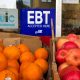 sign noting the acceptance of electronic benefit transfer (EBT) cards that are used by state welfare departments to issue benefits is displayed at a grocery store in 2019.