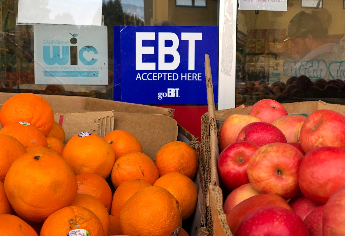 sign noting the acceptance of electronic benefit transfer (EBT) cards that are used by state welfare departments to issue benefits is displayed at a grocery store in 2019.