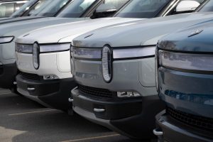 A Rivian electric vehicles sit in a lot at a Rivian facility in February 22, 2024 in Chicago, Illinois.