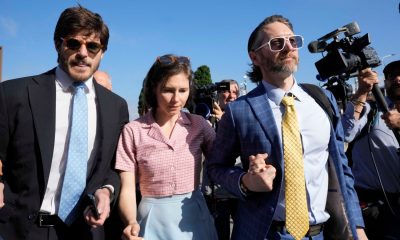 FILE - Amanda Knox arrives flanked by her husband Christopher Robinson, right, and her lawyer Luca Luparia Donati at the Florence courtroom in Florence, Italy, Wednesday, June 5, 2024. (AP Photo/Antonio Calanni, File)