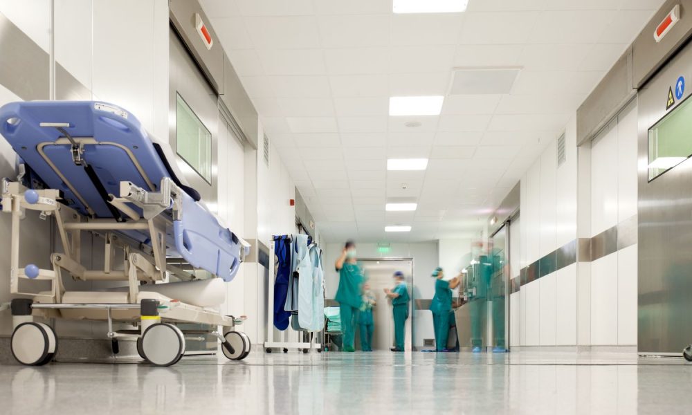 Blurred figures of people with medical uniforms in hospital corridor. Pic: iStock