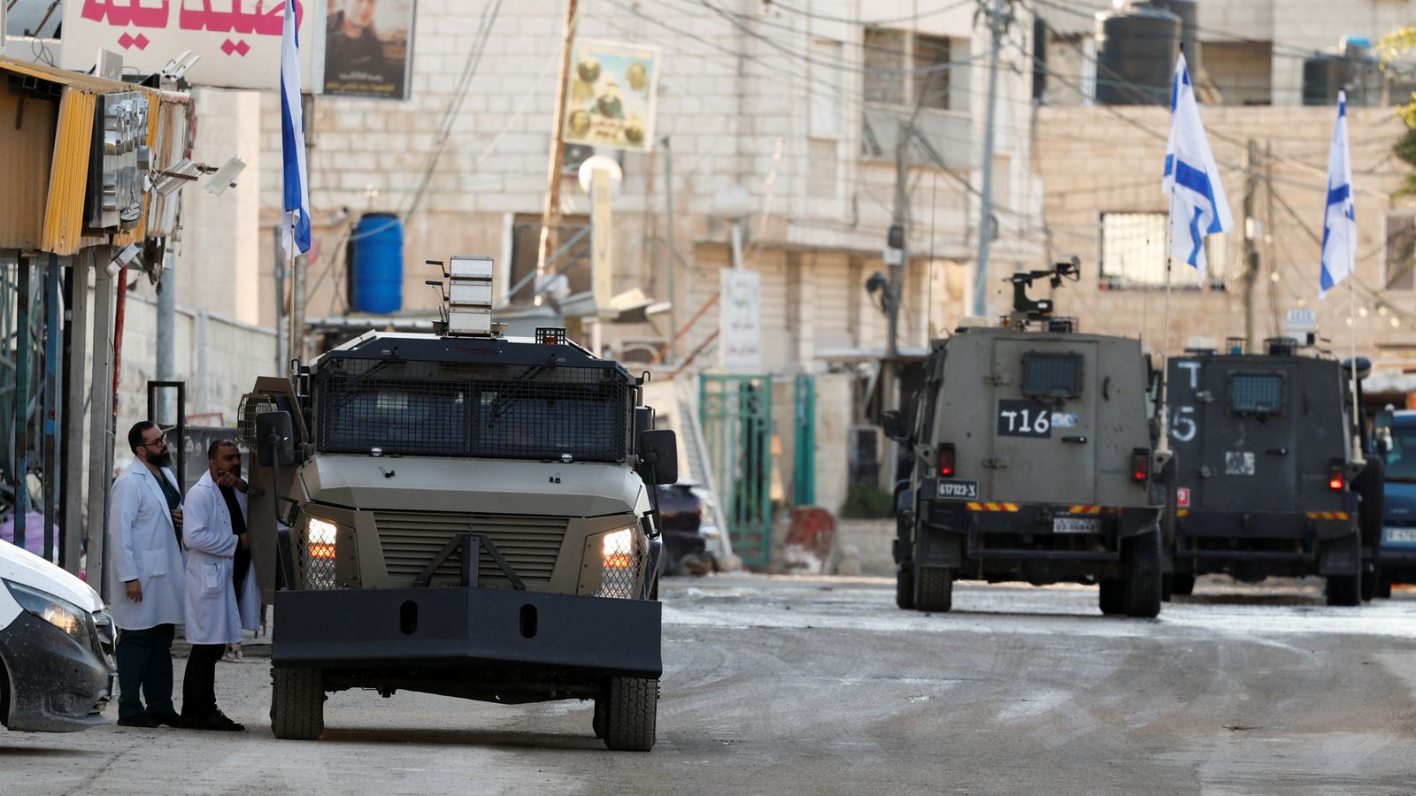 Israeli military vehicles drive on the street during an Israeli raid, in Jenin, in the Israeli-occupied West Bank, January 21, 2025. REUTERS/Raneen Sawafta