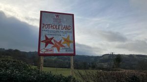 ‘Pothole Land’: Residents of Wrexham village turn road into tourist attraction | UK News