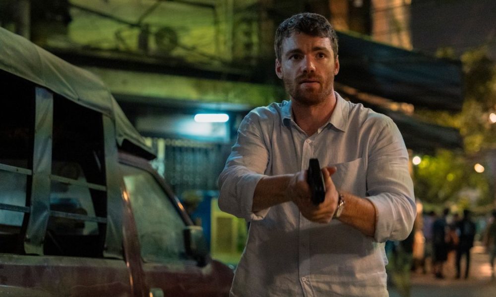 Peter holds up a gun in The Night Agent season 2