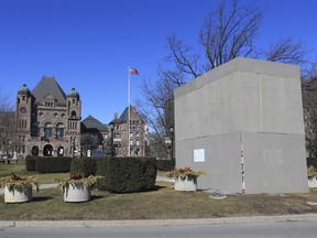 A Sir John A. Macdonald statue is boarded up.