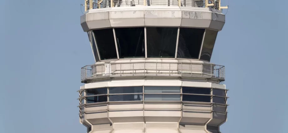 The air traffic control tower at Ronald Reagan Washington National Airport is pictured, Saturday, Feb. 1, 2025, in Arlington, Virginia, near the wreckage of a mid-air collision between a Black Hawk helicopter and an American Airlines jet in the Potomac River.