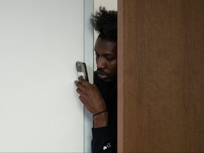 Raptors forward Chris Boucher leans through a doorway