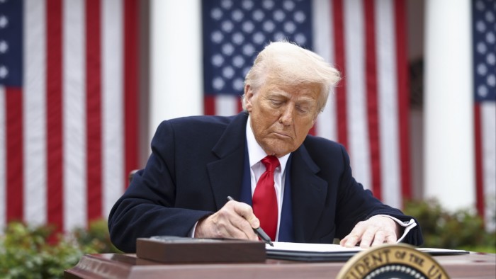President Donald Trump signs an executive order