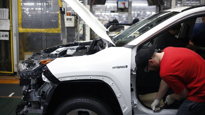Workers install components on a RAV4 hybrid sport utility vehicle at a Toyota plant in Kentucky, US