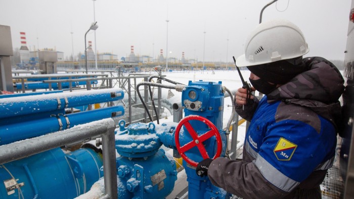 A worker adjusts a pipeline valve at the Gazprom compressor station, the starting point of the Nord Stream 2 gas pipeline