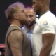 Anthony Joshua towers over rival Jake Paul in first face-off