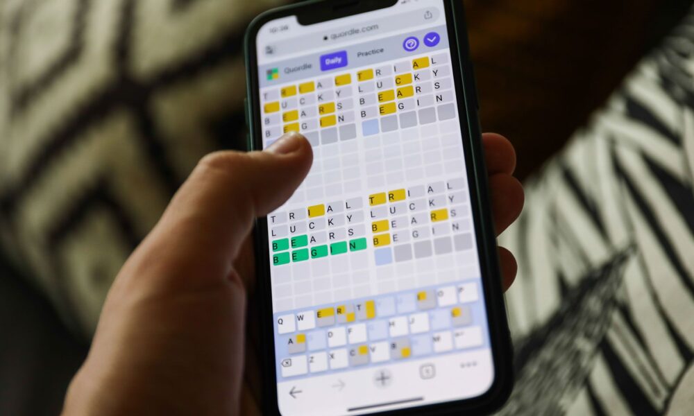 Quordle on a smartphone held in a hand