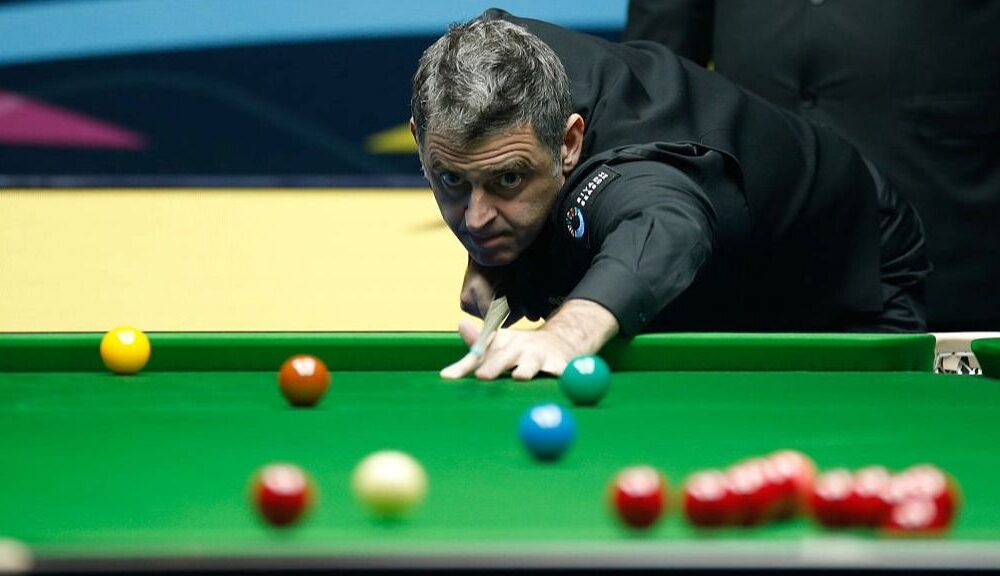 Snooker player Ronnie O&#039;Sullivan takes a shot, with red, yellow, green, brown and blue balls visible