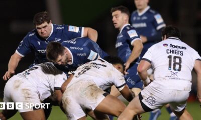 Tom Curry of Sale runs into three Exeter defenders