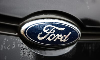 A Ford logo is seen on a gray car.