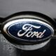 A Ford logo is seen on a gray car.