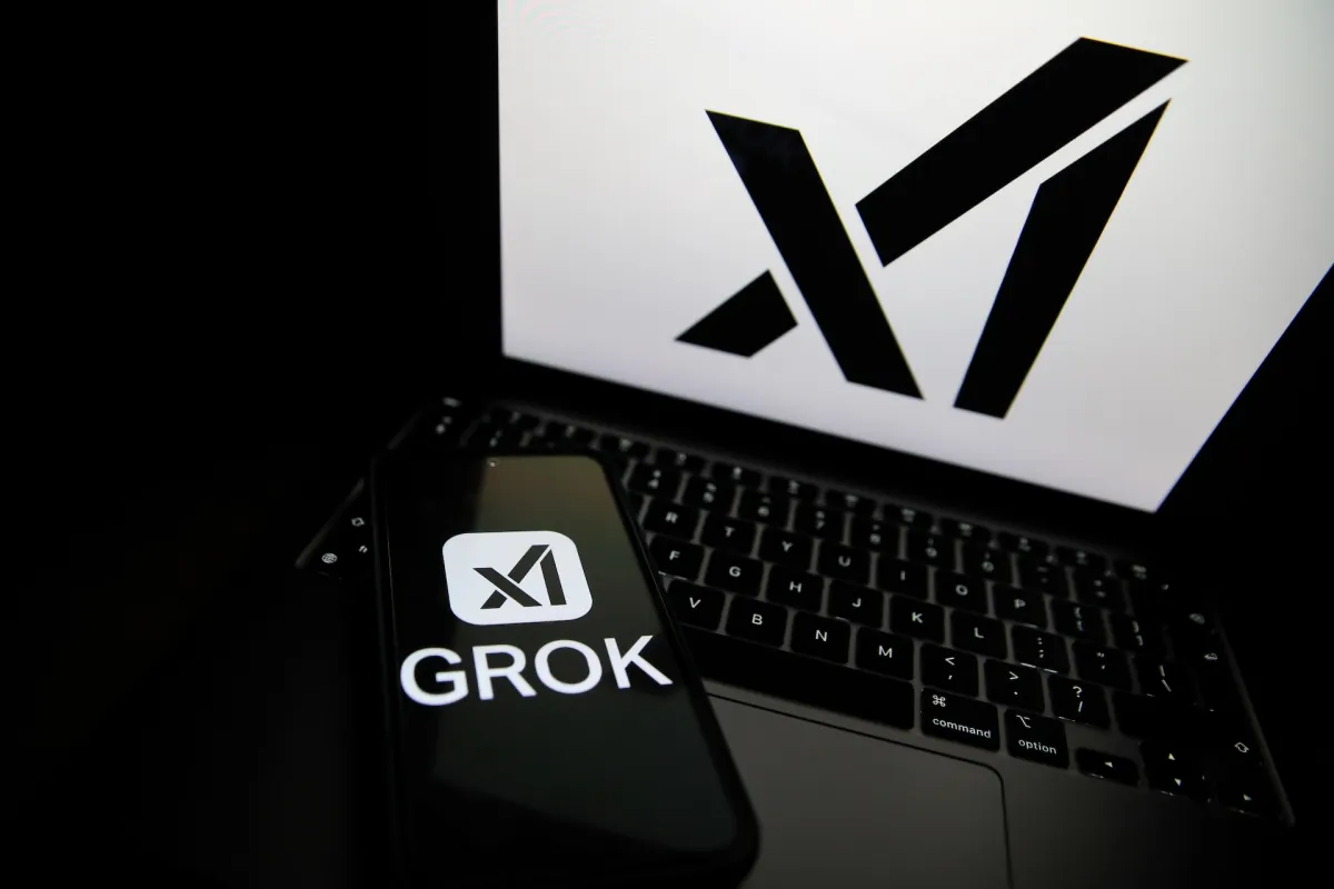 The Grok logo appears on a phone and the xAI logo is displayed on a laptop.