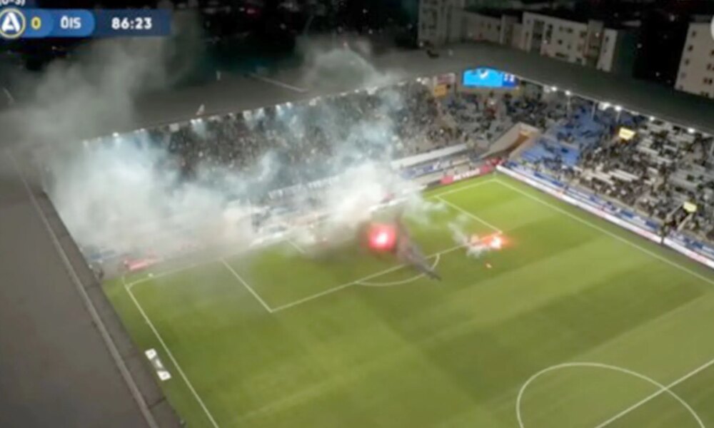 Swedish football match descends into chaos with pitch set on fire and referee hauling players off the pitch