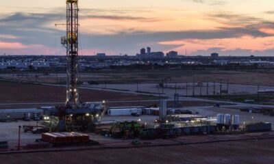 Oil climbs after hitting one-month low; supply glut weighs