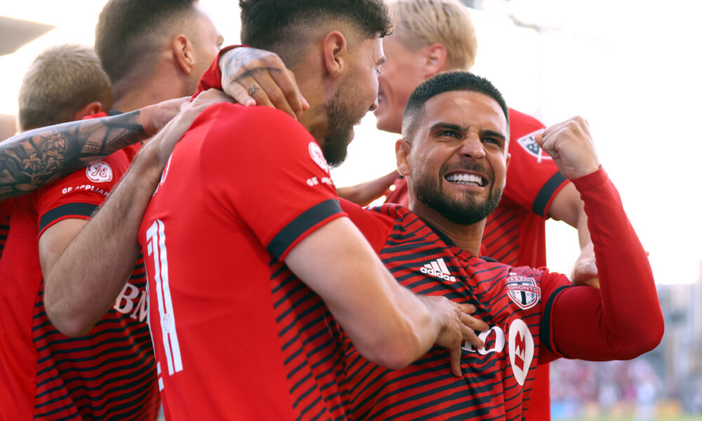 TORONTO, ON - JULY 23: Jonathan Osorio #21 of Toronto FC celebrates a goal with Lorenzo Insigne (R) #24 and teammates in an MLS game against Charlotte FC at BMO Field on July 23, 2022 in Toronto, Ontario, Canada. (Photo by Vaughn Ridley/Getty Images)
