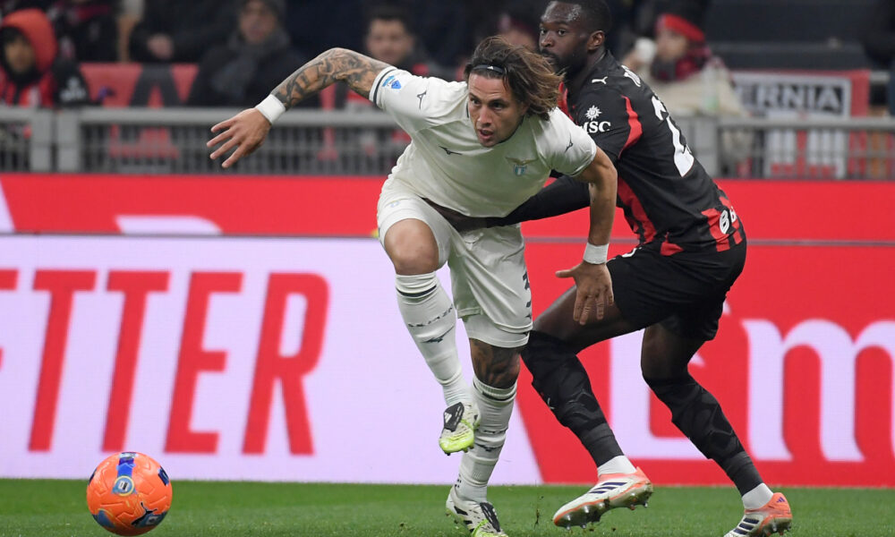 MILAN, ITALY - NOVEMBER 29: Luca Pellegrini of SS Lazio compete for the ball with Fikayo Tomori of AC Milan during the Serie A match between AC Milan and SS Lazio at Giuseppe Meazza Stadium on November 29, 2025 in Milan, Italy. (Photo by Marco Rosi - SS Lazio/Getty Images)