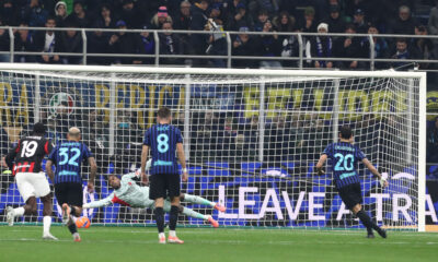 MILAN, ITALY - NOVEMBER 23: Mike Maignan of AC Milan saves a penalty kick Hakan Calhanoglu of FC Internazionale during the Serie A match between FC Internazionale and AC Milan at Giuseppe Meazza Stadium on November 23, 2025 in Milan, Italy. (Photo by Marco Luzzani/Getty Images)