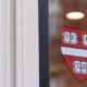 Logo of Harvard University on a window