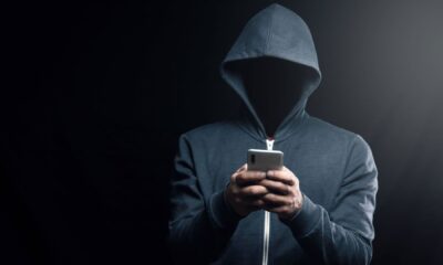 A dark figure in a hoodie representing a hacker.