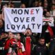 Manchester United fans with a banner complaining about raising prices