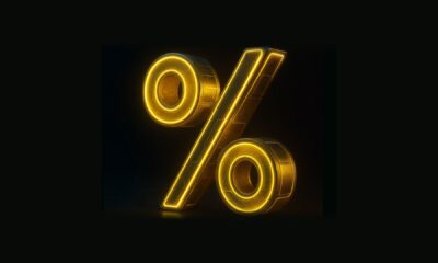 A gold percentage sign against a black background.