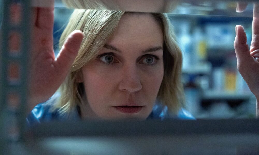 Carol peering through an empty shelf in Pluribus episode 4