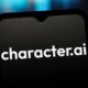 The character.ai logo is seen on a black screen on a phone.