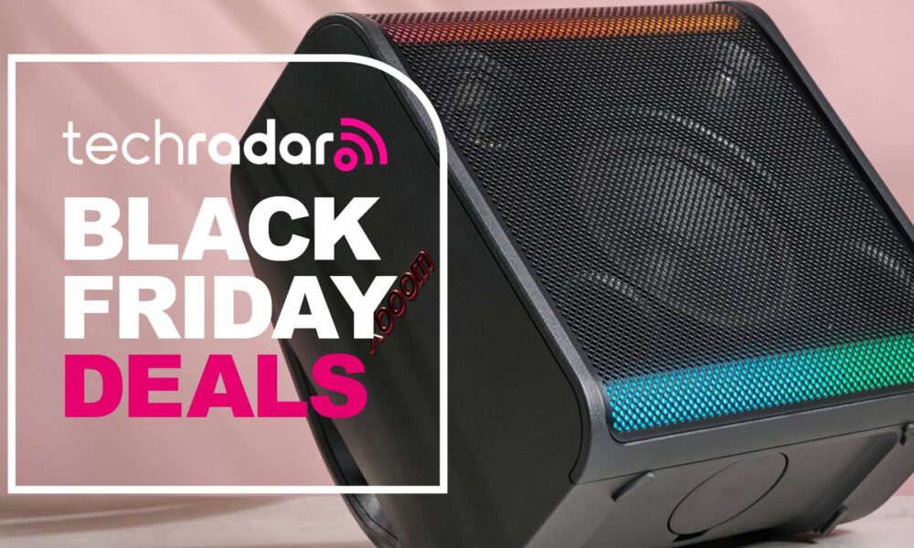LG xboom Stage 301 on pink background with the words &#039;TechRadar: Black Friday deals&#039; on left side of the image