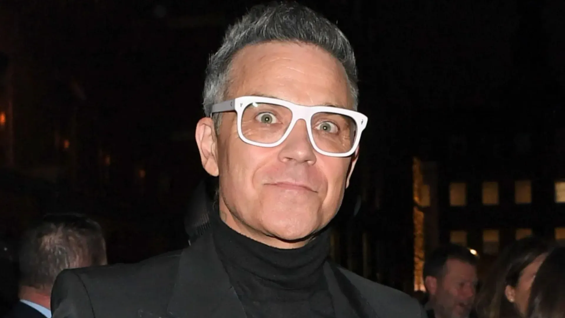 Robbie Williams steps out in chunky white specs after claiming fat jabs are ruining his eyesight