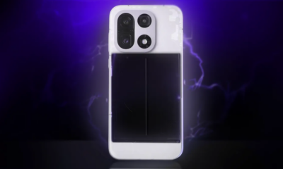 A OnePlus 15 with part of its back removed showing its internal battery