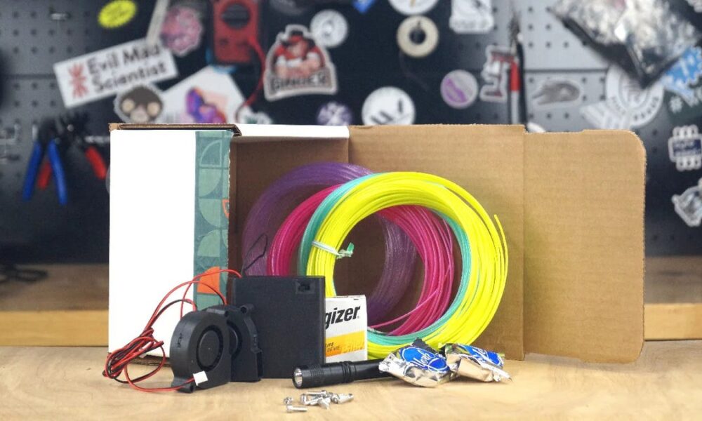 A small 3D-printed air hockey table on a white background