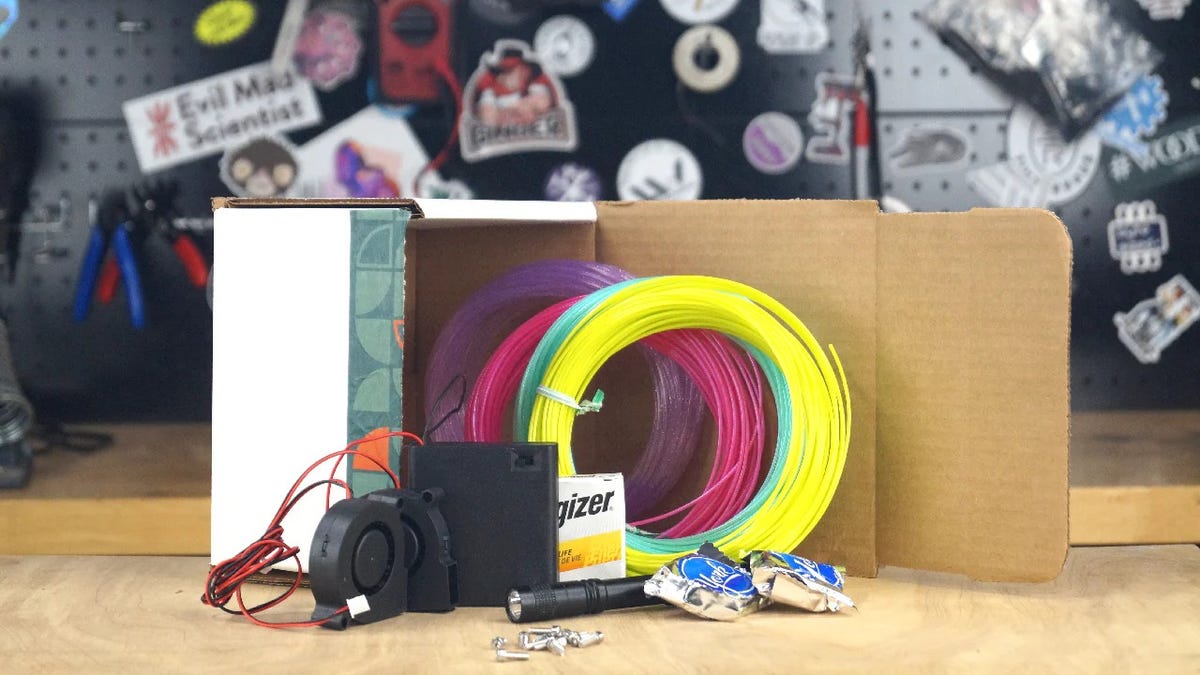 A small 3D-printed air hockey table on a white background