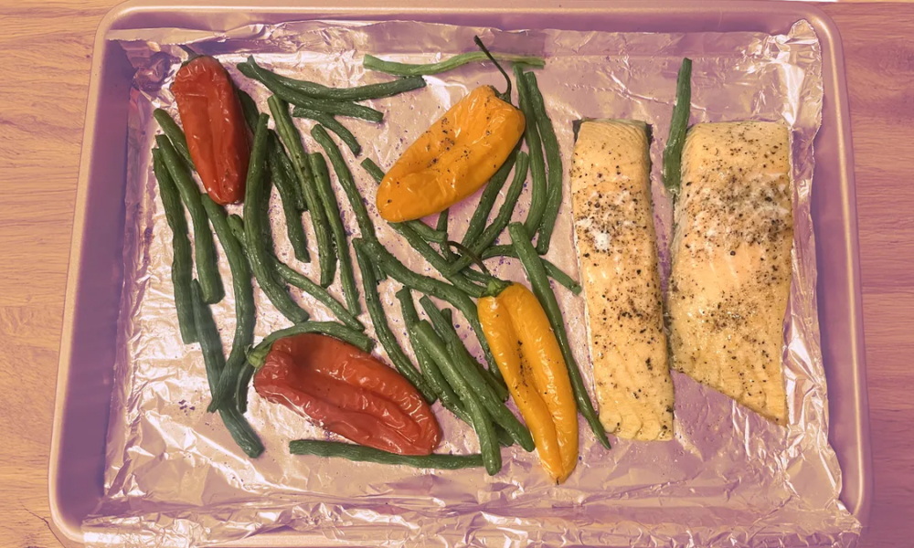 a pan with salmon and vegetables on it