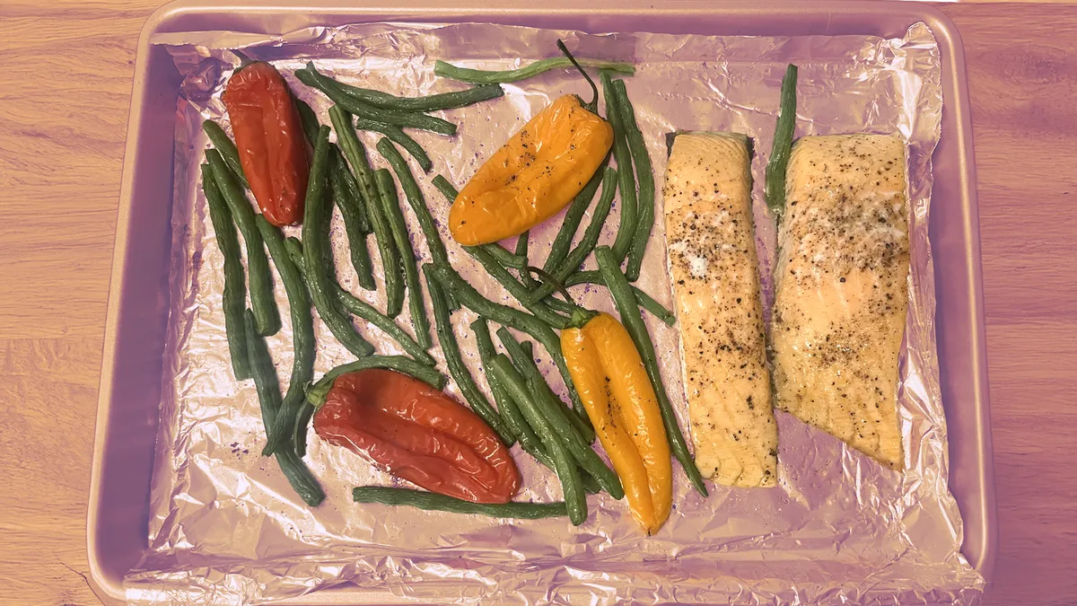 a pan with salmon and vegetables on it