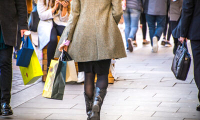 A,Shopping,High,Street,Scene,With,Woman,Carrying,Shopping,Bag