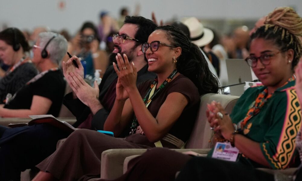 Delegates cheer at the passing of an article during a plenary session at COP30. Pic: AP